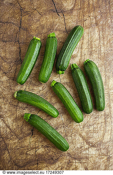 Studio shot of zucchinis lying on wooden surface
