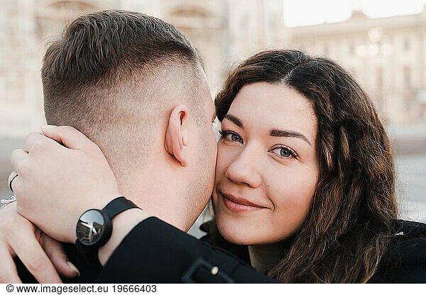 Stylish couple in love walking on Duomo square in Milan
