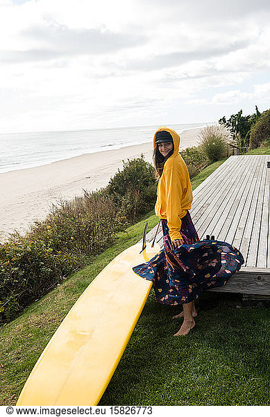 Stylish female surfer gets ready to surf