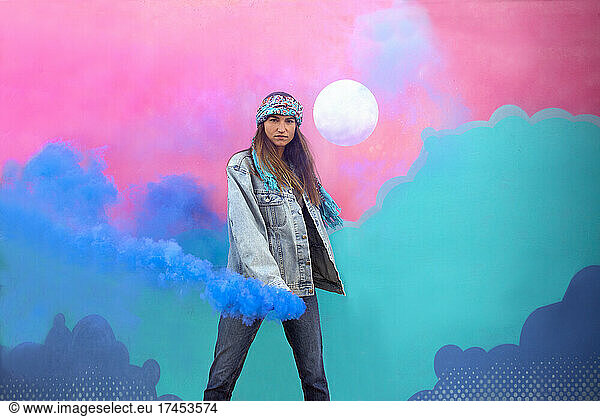 Stylish Girl With Smoke Bomb In Front Of Colorful Wall Mural Art