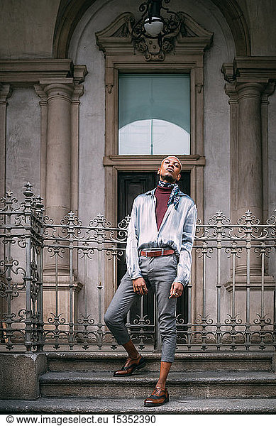 Stylish man standing on steps of period building  Milan  Italy