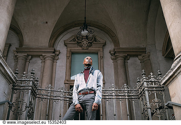 Stylish man standing on steps of period building  Milan  Italy