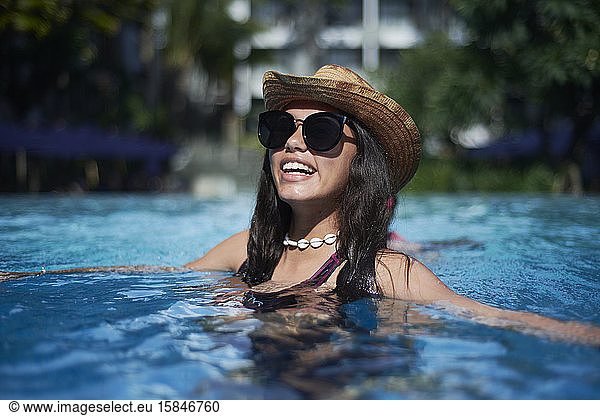 Stylish trendy young teen visco girl wearing a straw hat and necklace