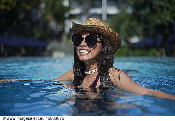 Stylish trendy young teen visco girl wearing a straw hat and necklace