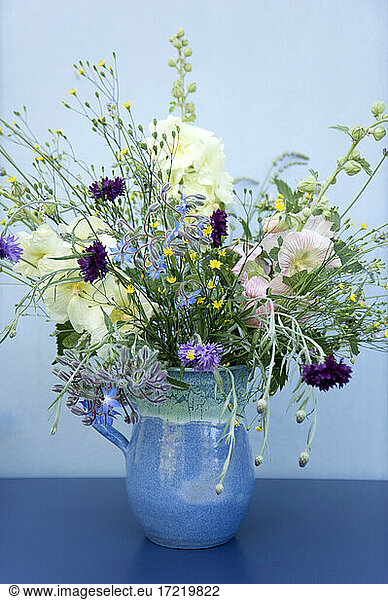 Summer flowers in blue jug