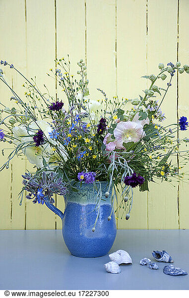 Summer flowers in blue jug
