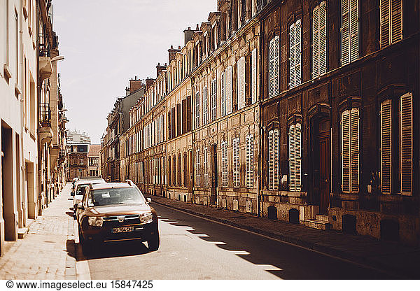 Summer street with standing cars in Reims  France