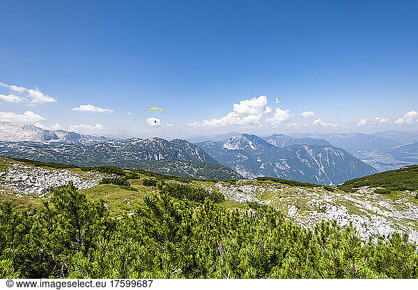 Summit of Krippenstein mountain in summer with paraglider in background
