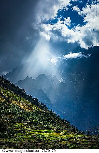 Sun rays through clouds in Himalayan valley in Himalayas. Lahaul valley  Himachal Pradesh  India  Asia