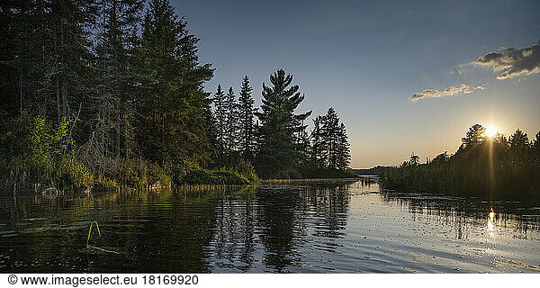Sun setting over a beautiful lake  Lake of the Woods  Ontario; Ontario  Canada