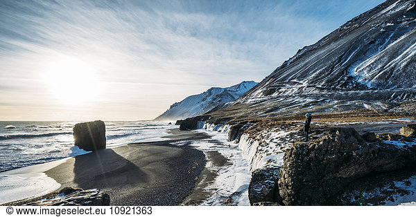 Sun shining over icy beach and mountains  Iceland