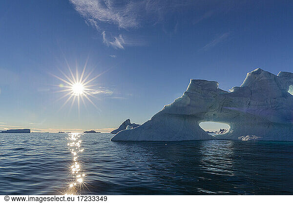 Sunburst on iceberg in De Dodes Fjord (Fjord of the Dead)  Baffin Bay  Greenland  Polar Regions