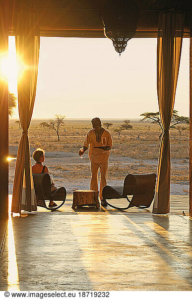 Sundowner drink served on deck  The Fort at Fisher's Pan  Onguma Safari Camp  near Etosha National Park  Kunene Region  Namibia