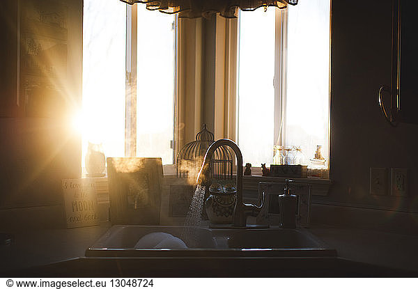 Sunlight emitting through window in kitchen at home