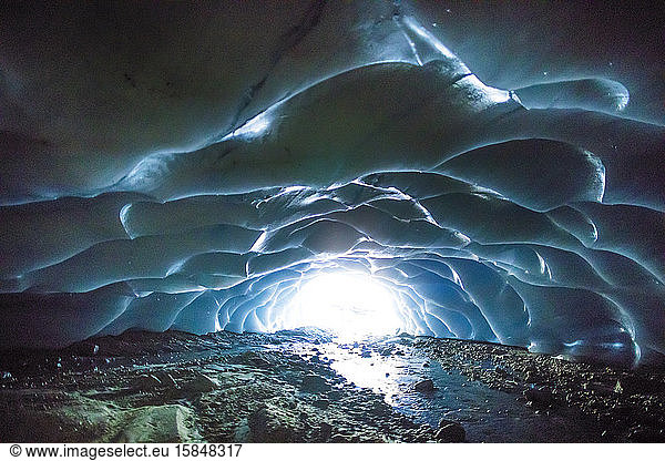 Sunlight enters a glacial cave.