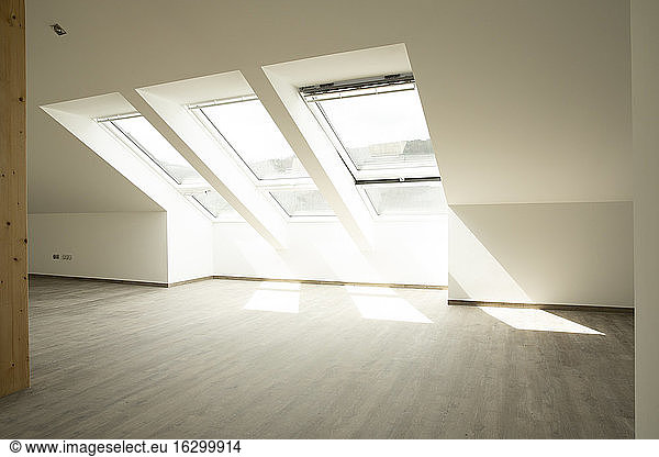 Sunlight falling through windows on floor in new house