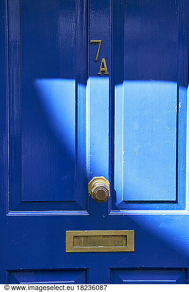 Sunlight on blue wooden house door