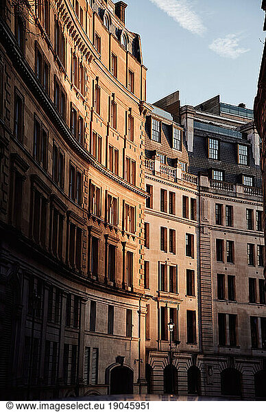 Sunlight on old buildings on city street