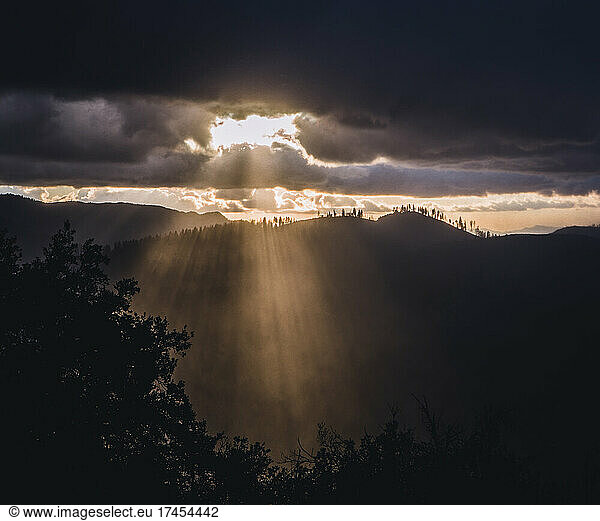 Sunlight rays burst through clouds after storm  Yosemite California