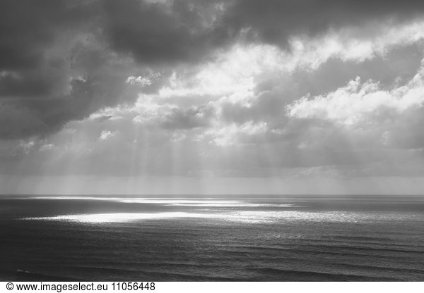 Sunlight through clouds over the ocean
