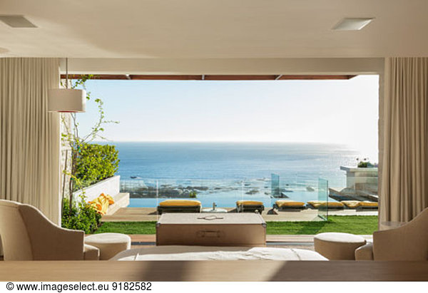Sunny bedroom and patio overlooking ocean