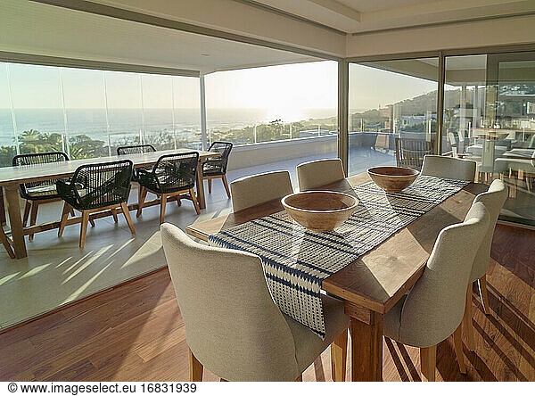Sunny home showcase interior dining room with scenic ocean view