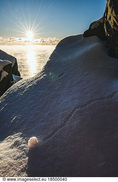 sunrise along snowy section of rocky Maine Coast  Cutler