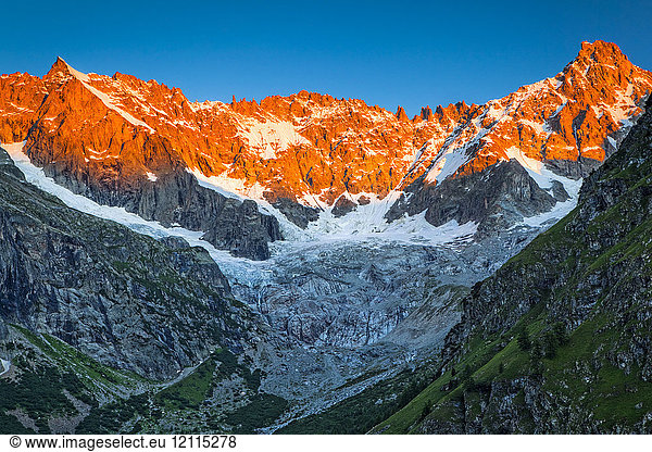 Sunrise glow on the peaks above l'A Neuve Glacier  viewed from La Fouly  Swiss Val Ferret  Alps; La Fouly  Val Ferret  Switzerland