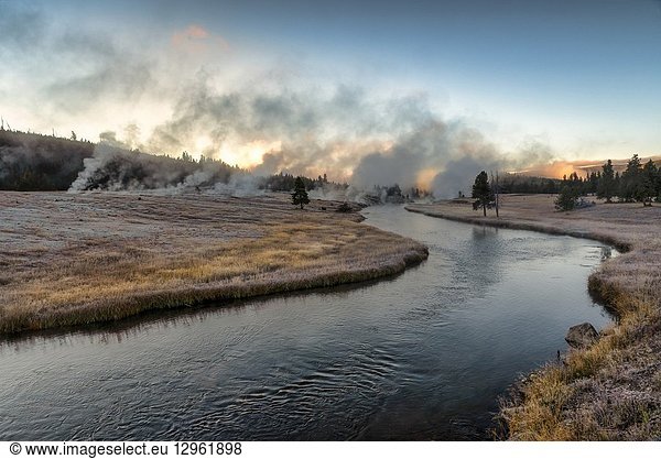 Sunrise over Thermal Activity on a Clear Frosty Fall morning on Freehole River Yellowstone National Park Wyoming USA.
