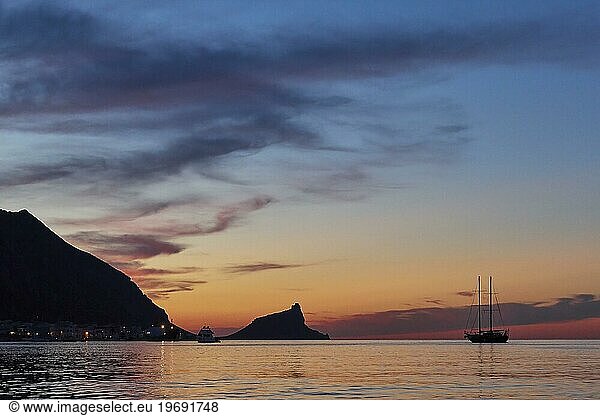 Sunset  dusk  grey clouds  sailboat  Castello di Punta Troia  boat tour  view from the sea  Marettimo  Egadi Islands  Sicily  Italy  Europe
