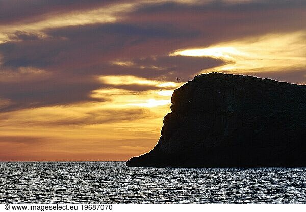 Sunset  dusk  orange sky  black rock  grey clouds  Marettimo  Egadi Islands  Sicily  Italy  Europe