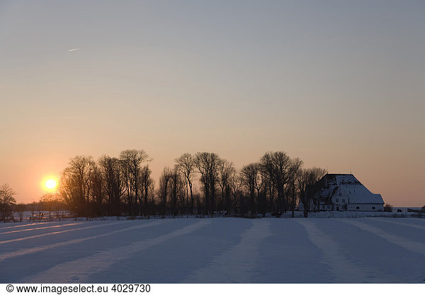 Sunset on the Roter Haubarg on a snow-covered marshland in Witzwort North Frisia Schleswig-Holstein North Germany Germany Europe