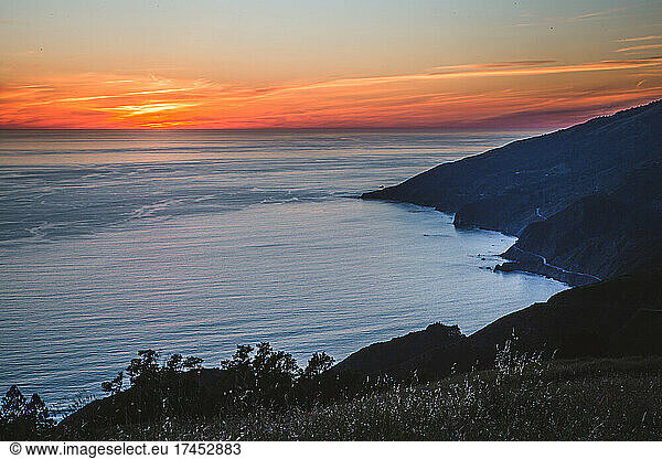 Sunset over Pacific Ocean and Big Sur Coast from mountain peak.