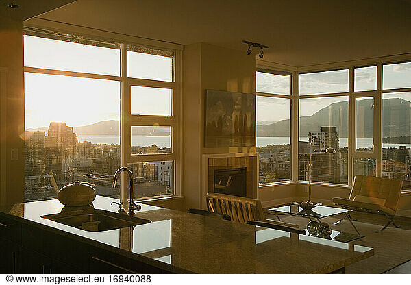 Sunset through windows of open plan apartment.
