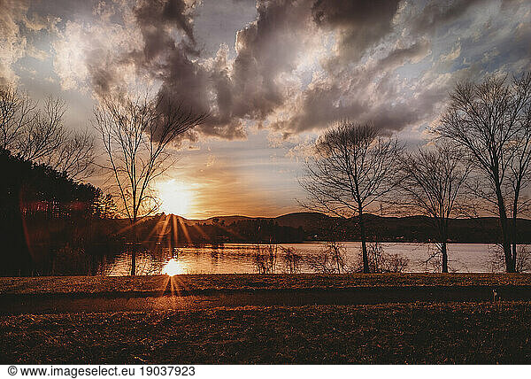 Sunset with double starburst at Pontoosuc Lake in Massachusetts
