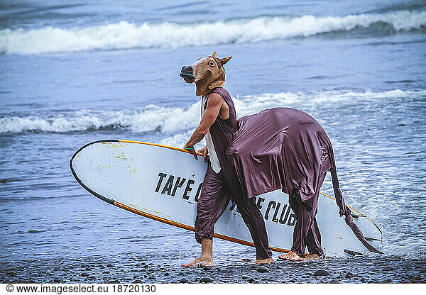 Surf in a carnival costumes  Bali  Indonesia. Just take a fun and play with a friends.