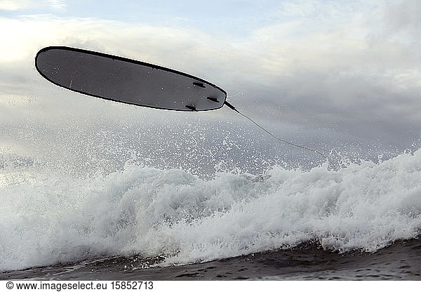 Surfboard in the air after a wipe-out