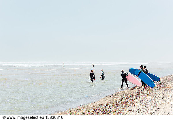 Surfers head out to see at a surf camp