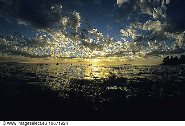 Surfers waiting for the last set of the day to come  at sunset. Santa Barbara  California.