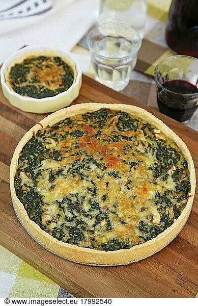 Swabian cuisine  spinach cake with shortcrust base  savoury cake  main course  bake  out of the oven  typical Swabian  vegetarian  healthy  traditional cuisine  water glasses  red wine  wooden board  food photography  studio  Germany  Europe