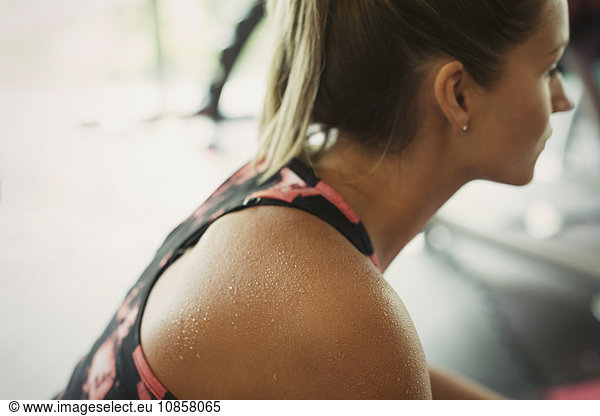 Sweating woman resting at gym
