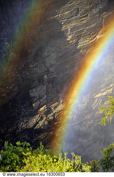 Sweden  Gaeddede  Rainbow at waterfall Haellingsafallet