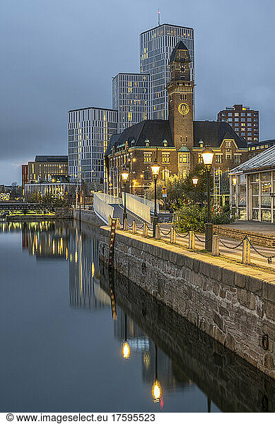 Sweden  Skane County  Malmo  City canal at dusk with World Maritime University and hotels in background