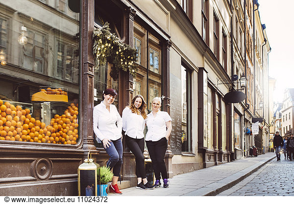 Sweden  Stockholm  Gamla Stan  Portrait of three female cafe workers standing outdoors
