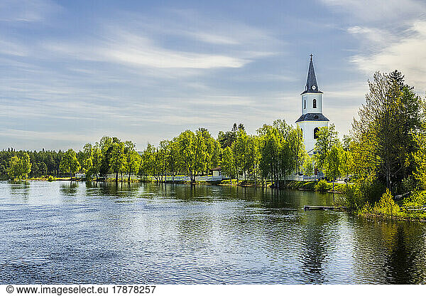 Sweden  Vasterbotten County  Sorsele  Lake in summer with church bell tower in background