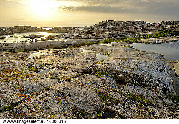 Sweden  Vastra Gotaland County  Grebbestad  Rocky landscape of Tjurpannans Nature Preserve at sunset