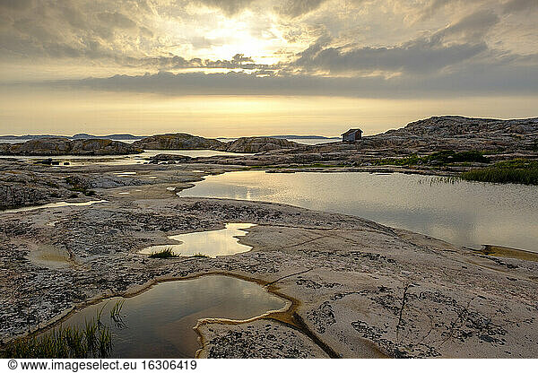 Sweden  Vastra Gotaland County  Grebbestad  Rocky landscape of Tjurpannans Nature Preserve at sunset