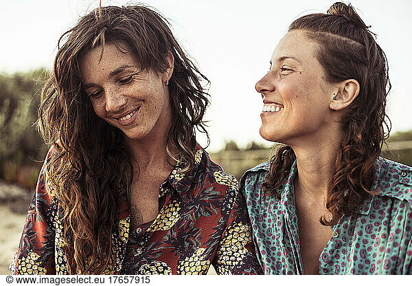 Sweet moment between pretty lesbian couple beach camping in Portugal