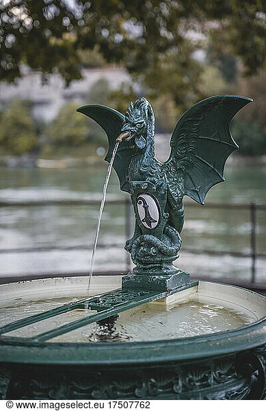 Switzerland  Basel-Stadt  Basel  Dragon sculpture decorating small drinking well