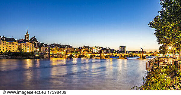 Switzerland  Basel-Stadt  Basel  Long exposure of river Rhine at dusk with Middle Bridge in background
